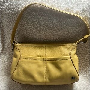 The Sak genuine leather, yellow in color handbag.